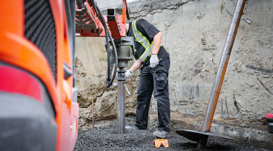 Man installing a helical pile in Winnipeg