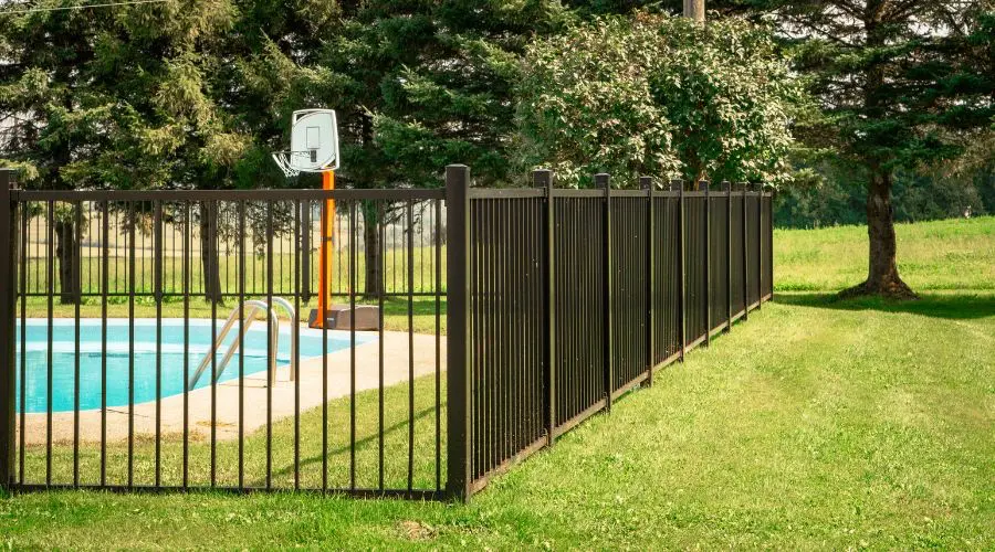 Screw pile fence bordering a pool